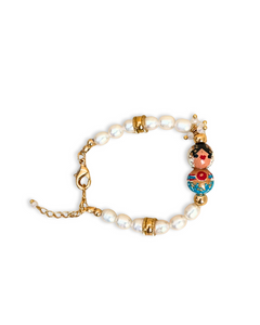 Pulsera Perlada Empollerada celeste, motita roja.